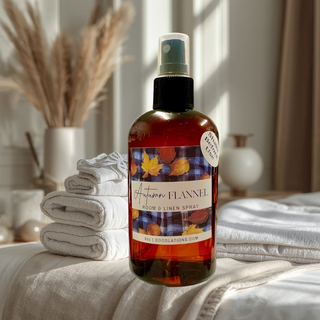 Doodlations Coffee Bar & Boutique Autumn Flannel room and linen spray in amber bottle with fall leaf label.