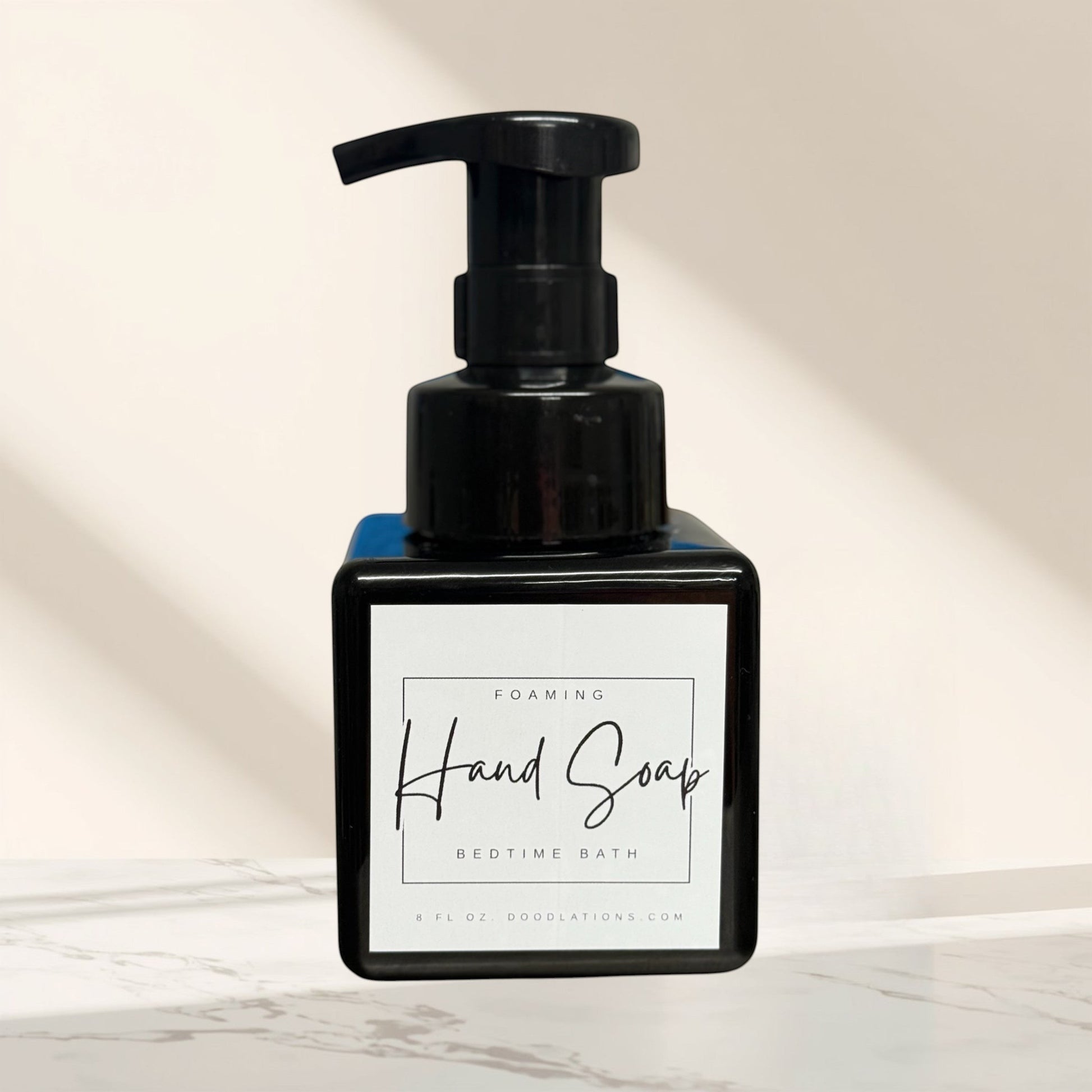 Doodlations Coffee Bar & Boutique Bedtime Bath foaming hand soap in a black square bottle with a white label.