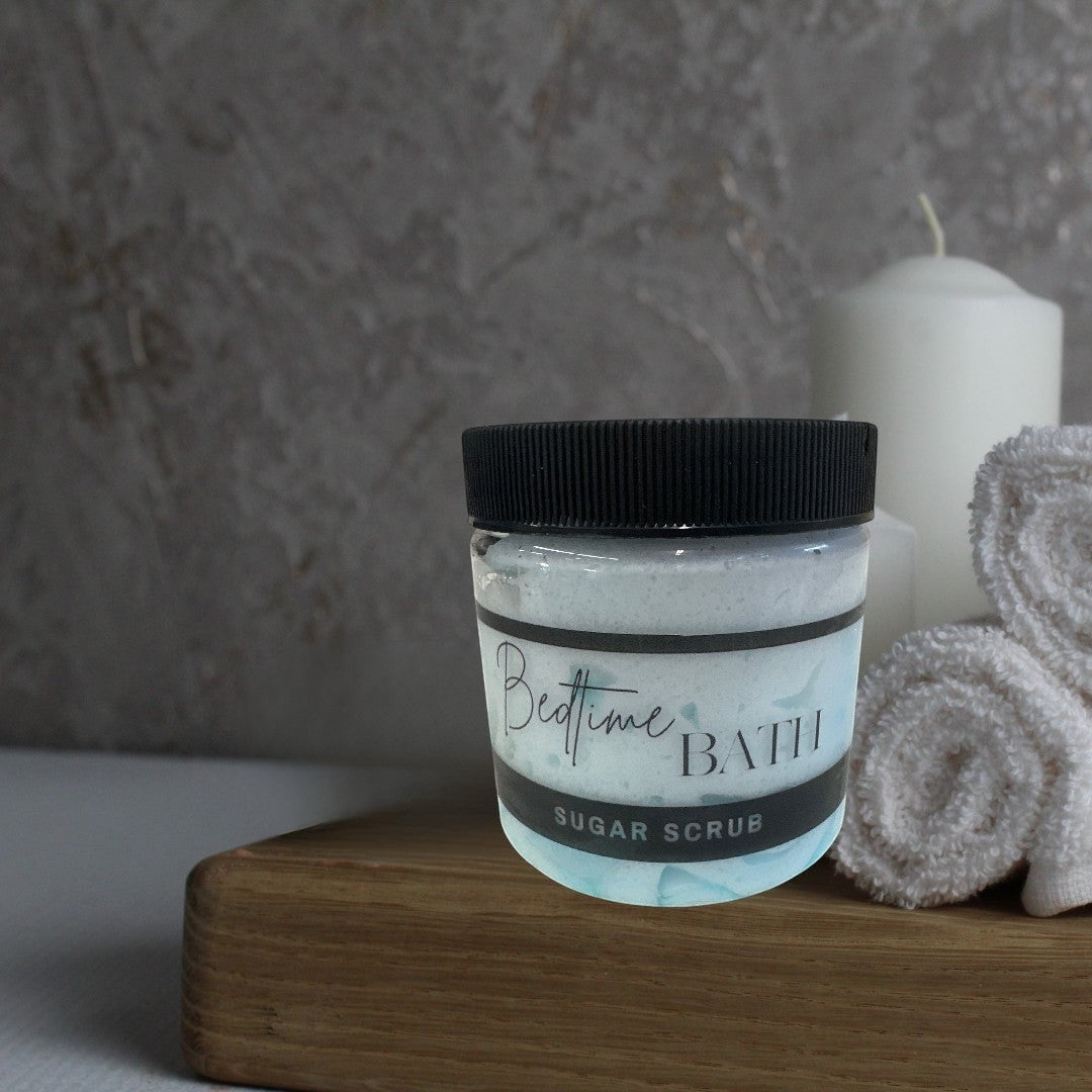 Doodlations Coffee Bar & Boutique Bedtime Bath sugar scrub in a clear jar with a black lid, light blue marbled texture.