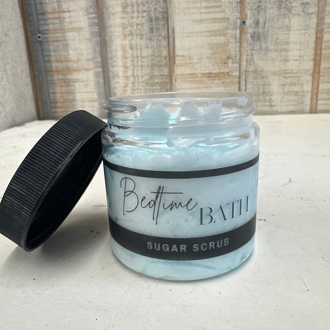 Doodlations Coffee Bar & Boutique Bedtime Bath sugar scrub in a clear jar with a black lid. Light blue scrub.