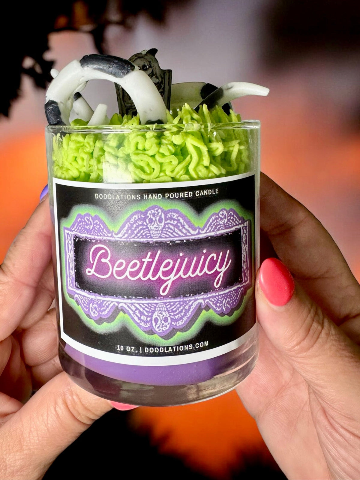 Doodlations Coffee Bar & Boutique Beetlejuicy luxury candle with green wax sandworm details in a glass jar