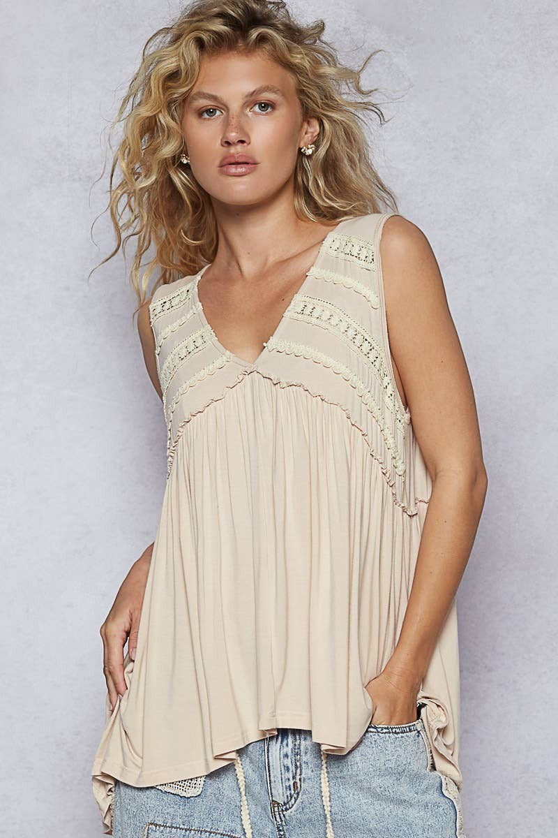 Doodlations Coffee Bar & Boutique sleeveless beige babydoll knit top with lace trim, V-neck, and ruffle details.