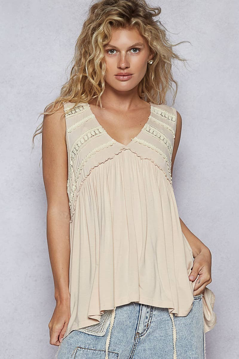 Doodlations Coffee Bar & Boutique sleeveless beige babydoll knit top with lace trim, V-neck, and ruffle details.