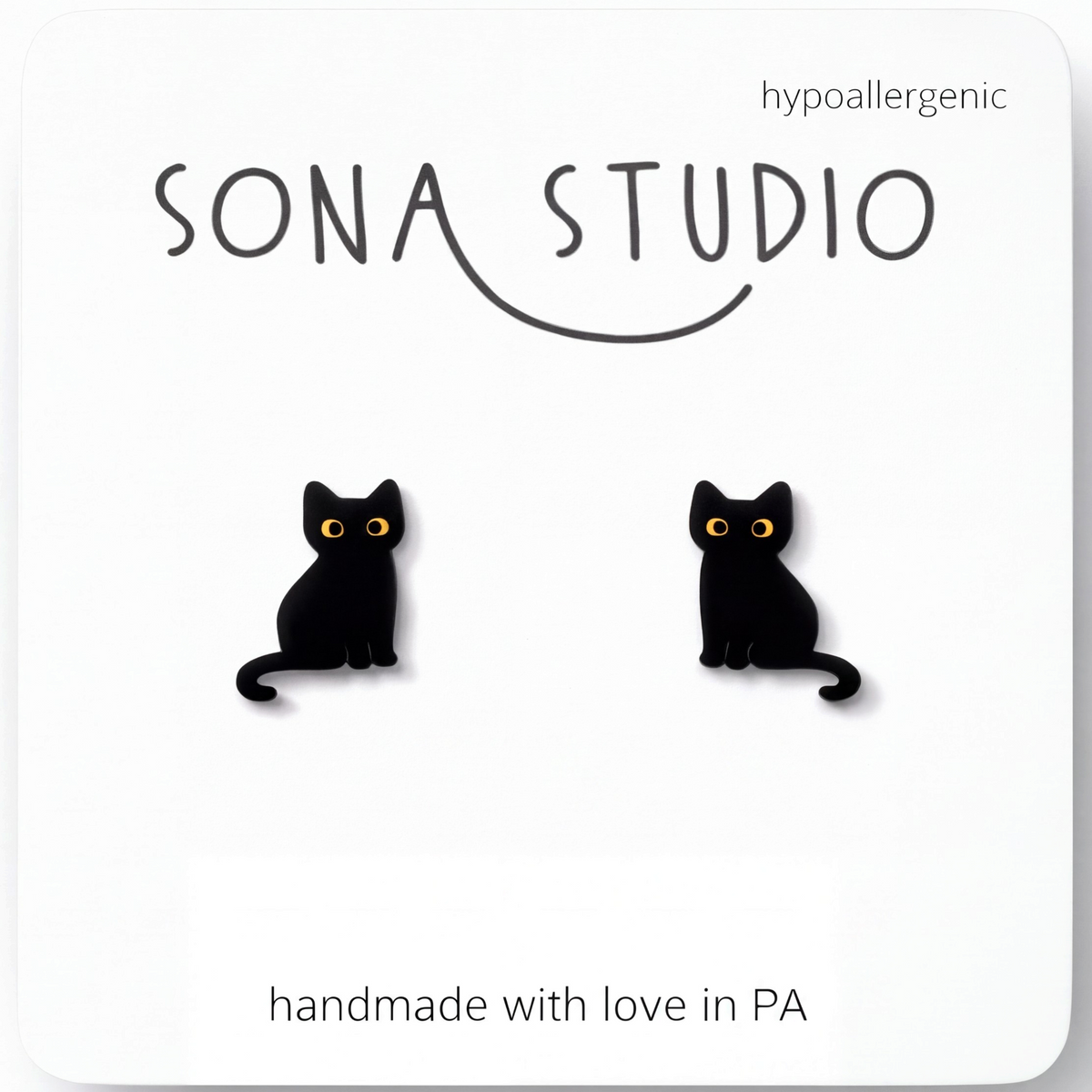 Doodlations Coffee Bar & Boutique black cat stud earrings with yellow eyes, crafted from lightweight plastic.