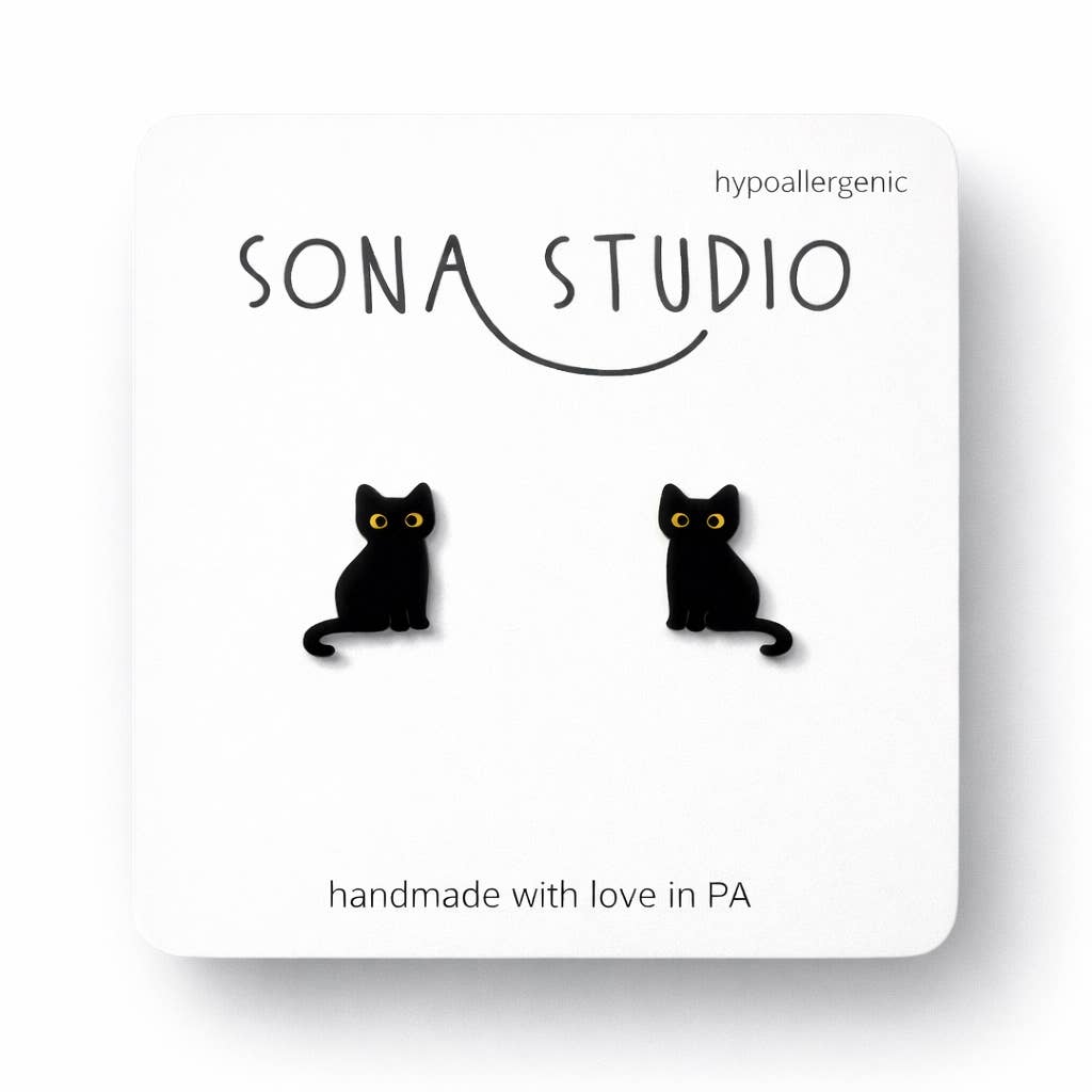 Doodlations Coffee Bar & Boutique black cat stud earrings with hypoallergenic stainless steel posts on display card.