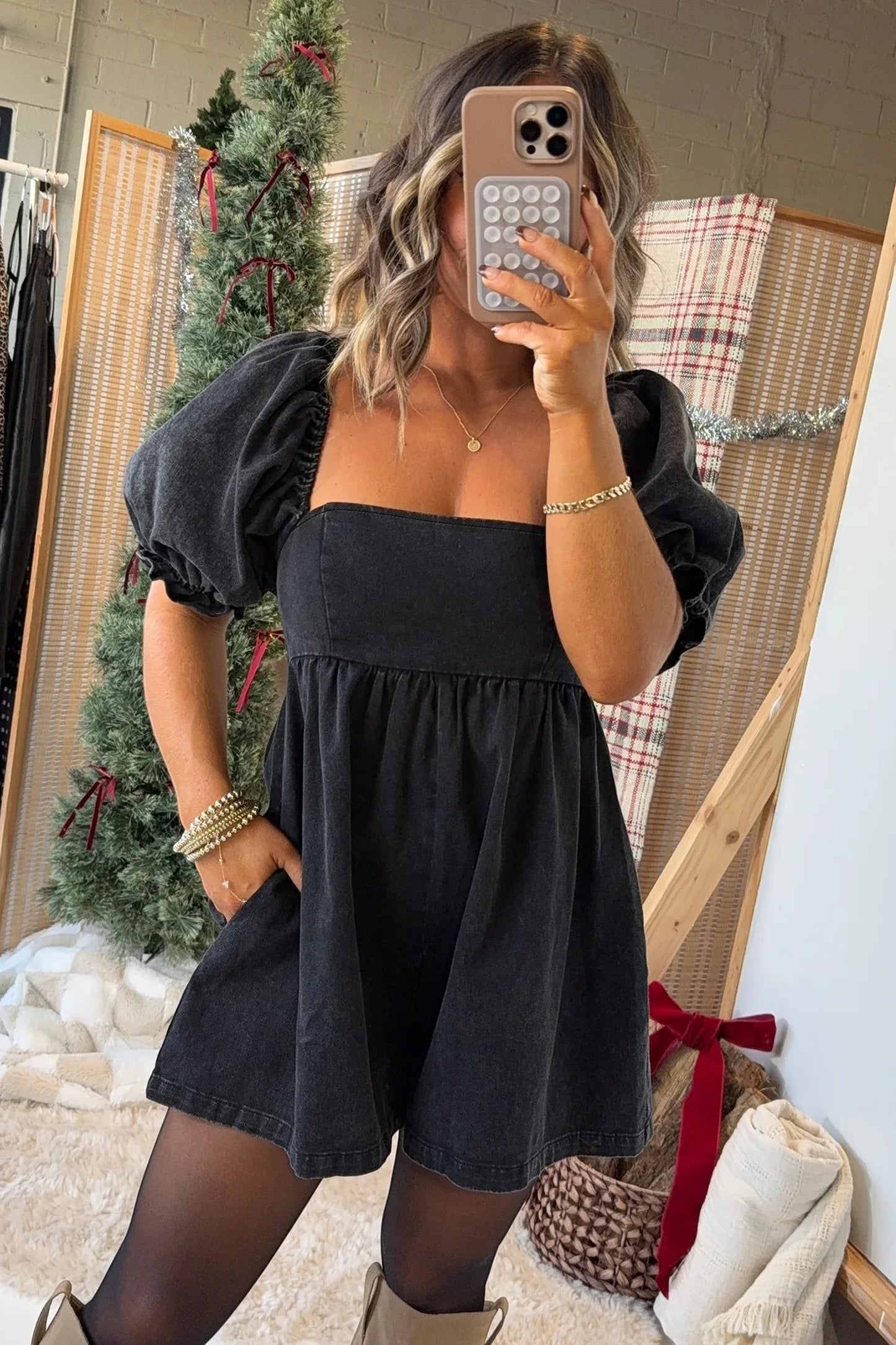 Doodlations Coffee Bar & Boutique black denim romper with square neckline, puff sleeves, and smocked bodice detail.