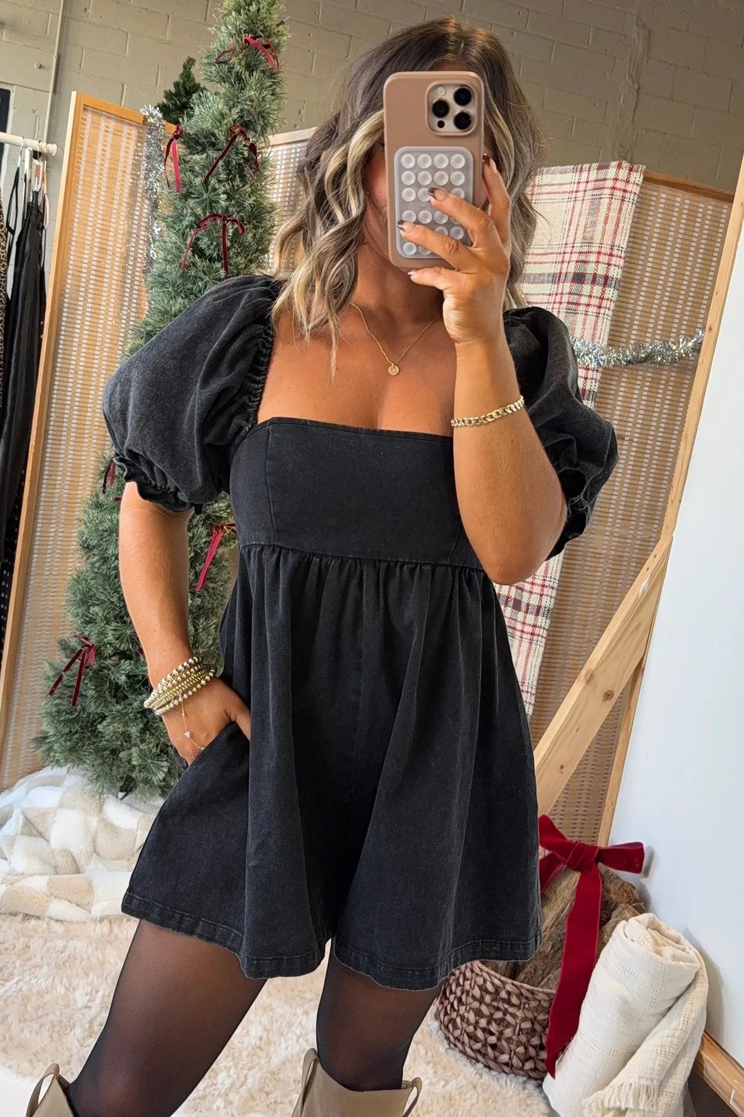 Doodlations Coffee Bar & Boutique black denim romper with square neckline, puff sleeves, and smocked bodice detail.