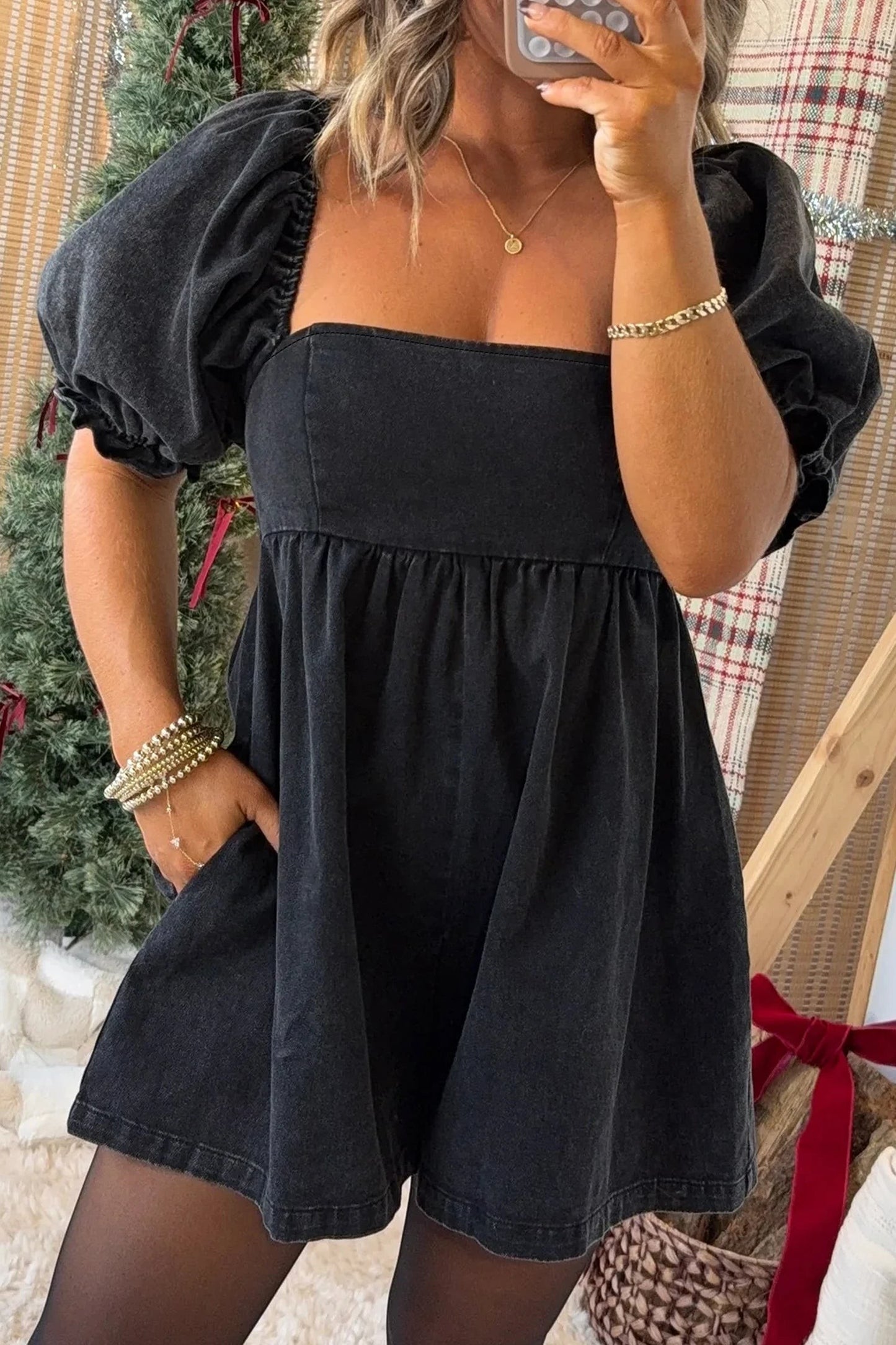 Doodlations Coffee Bar & Boutique black denim romper with square neckline, puff sleeves, and smocked bodice detail.