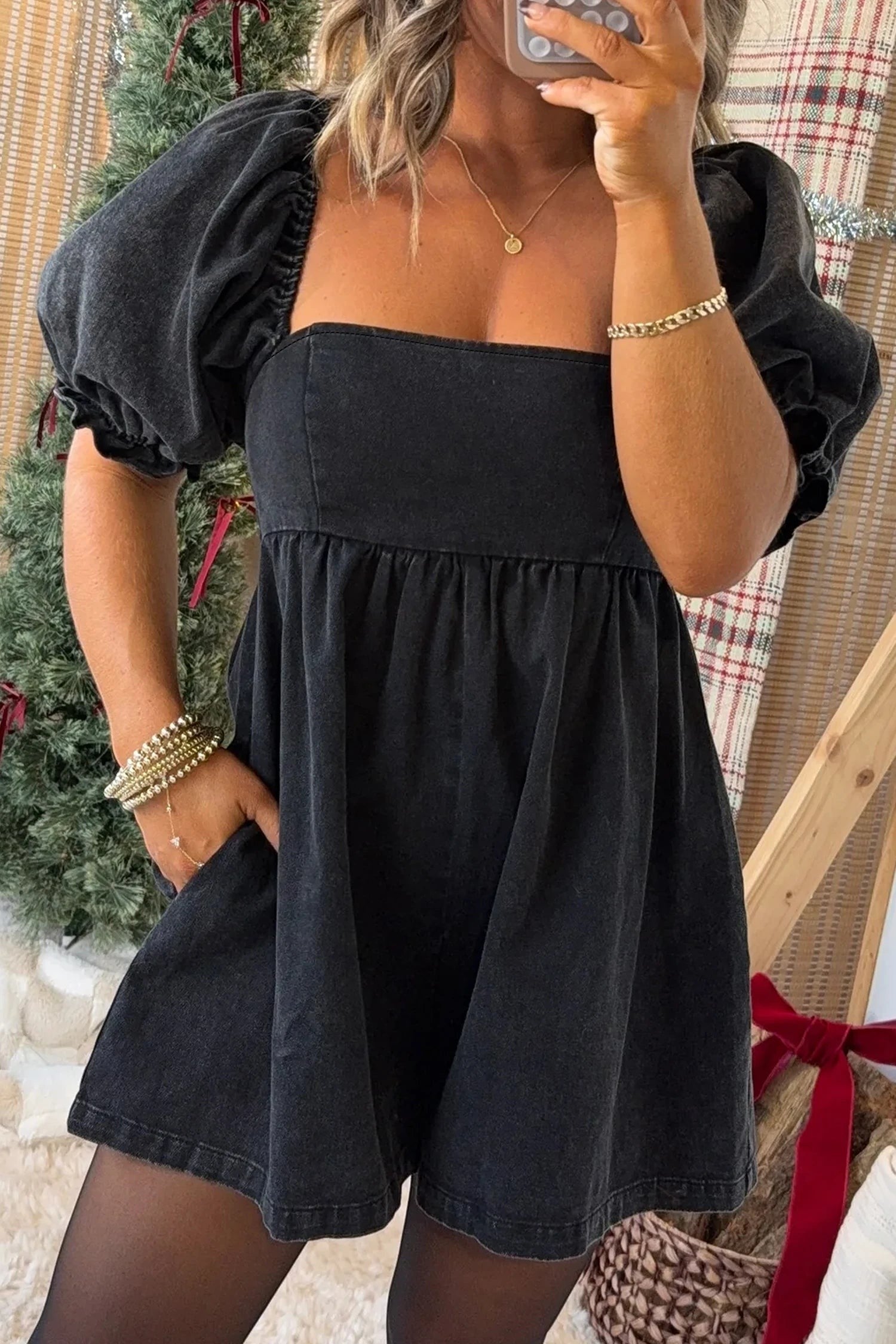 Doodlations Coffee Bar & Boutique black denim romper with square neckline, puff sleeves, and smocked bodice detail.