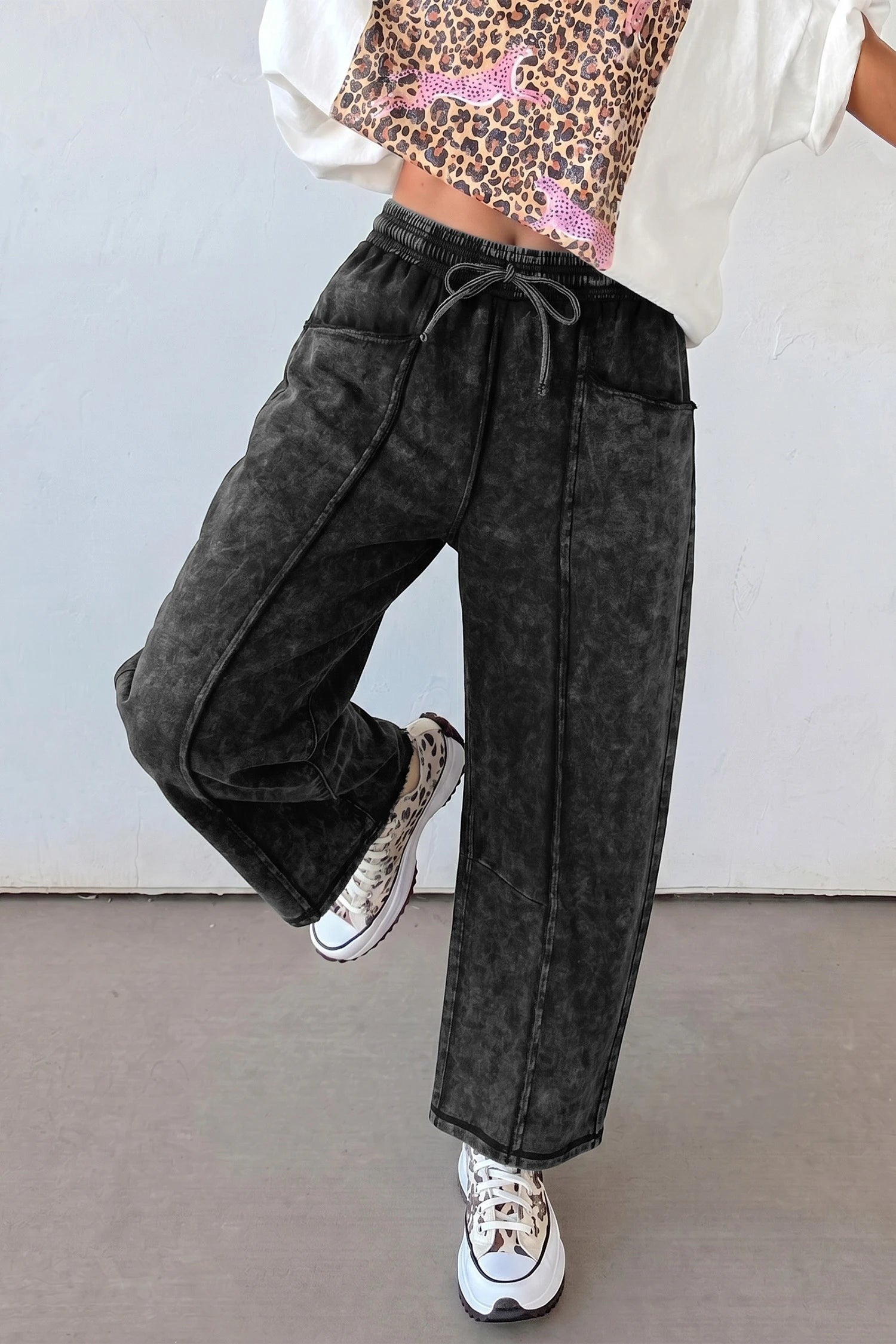 Doodlations Coffee Bar & Boutique black mineral wash barrel pants with raw seams, elastic waist, and drawstring.