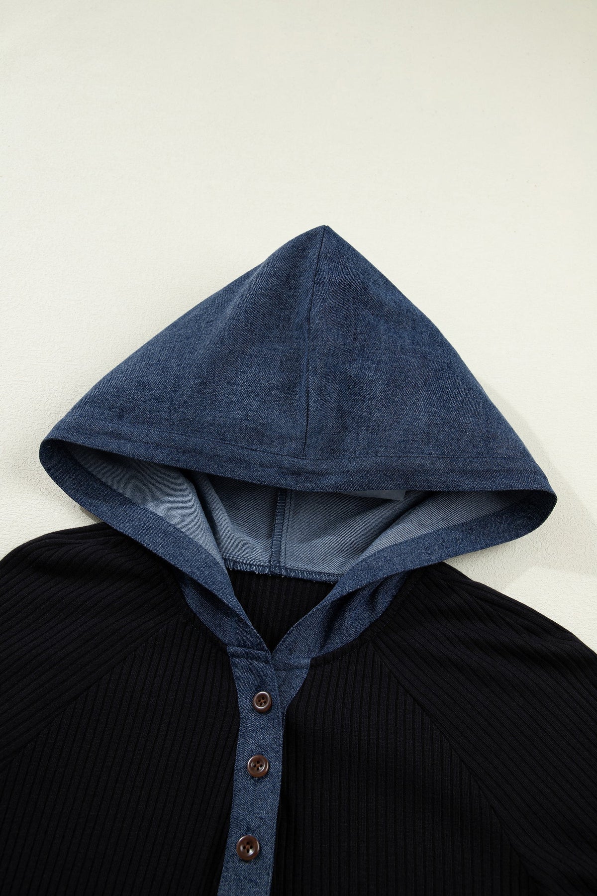 Doodlations Coffee Bar & Boutique black ribbed knit long sleeve top with a blue denim hood and button-up placket.