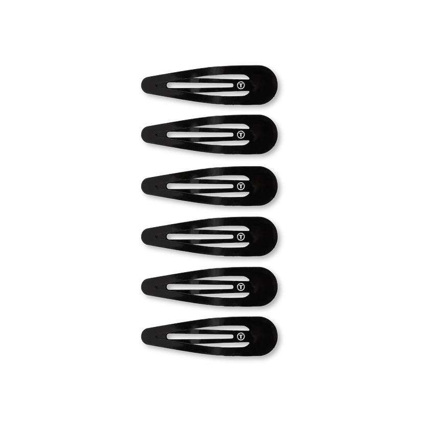 Six black TELETIES Snap Clip hair clips with a smooth, snag-free finish and branded T logo on each.