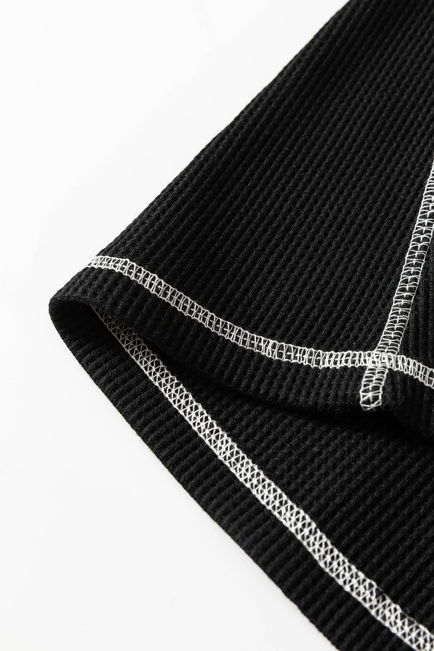 Doodlations Coffee Bar & Boutique black waffle knit top featuring white contrast stitching on the seams