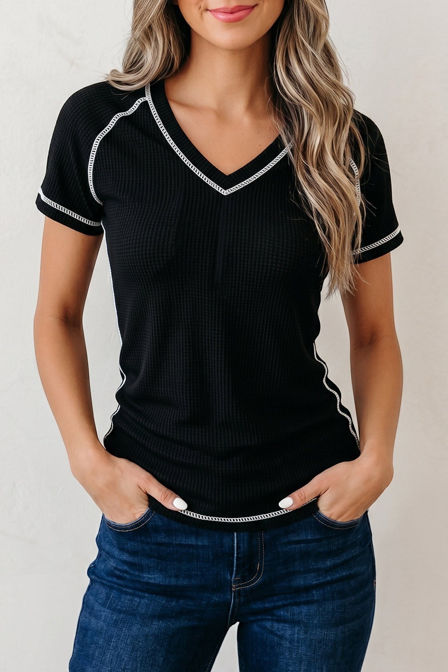 Doodlations Coffee Bar & Boutique black waffle knit V-neck top with white contrast stitching and short sleeves.