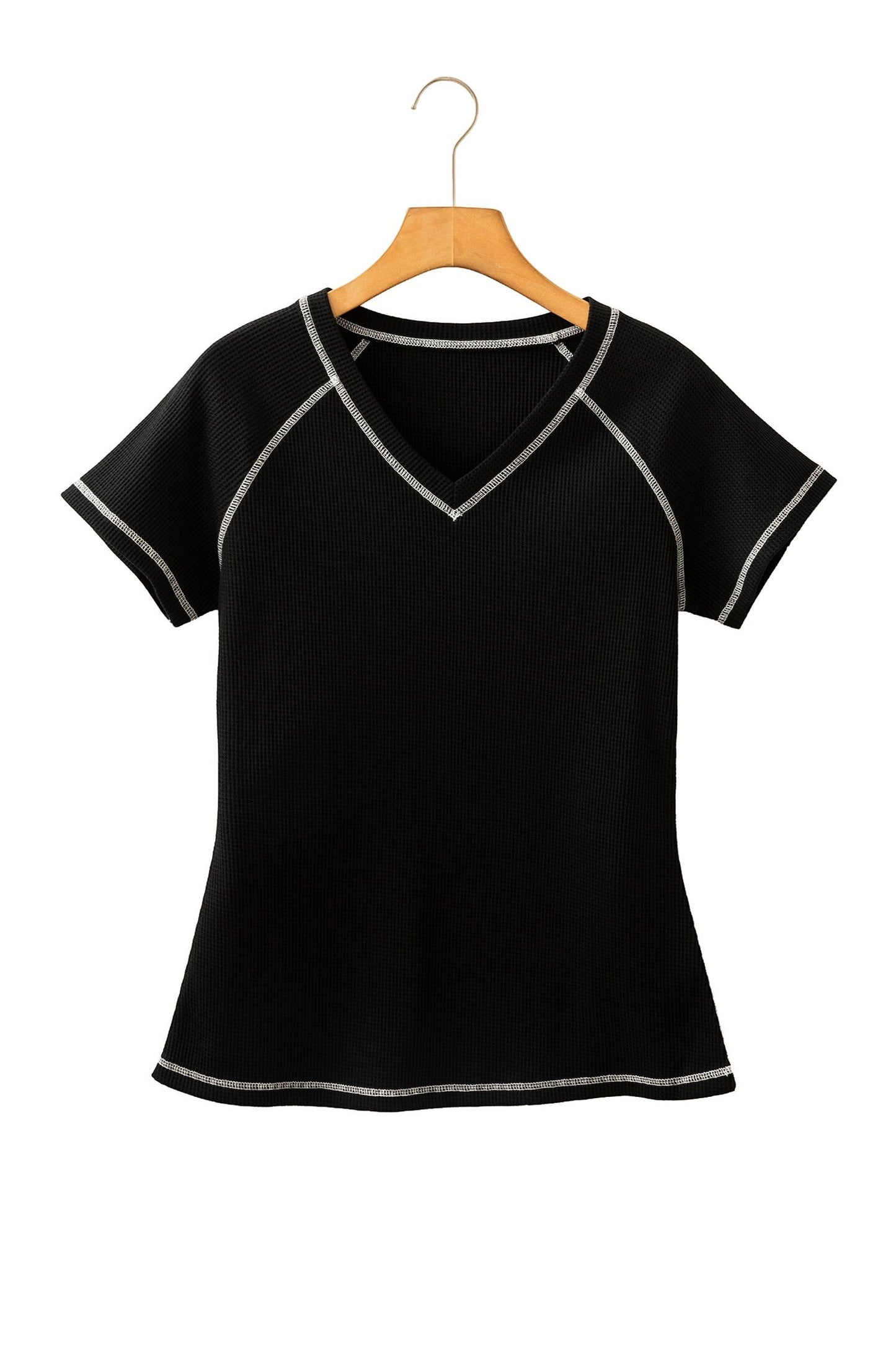 Doodlations Coffee Bar & Boutique black waffle knit V-neck top with white contrast stitching on a wooden hanger