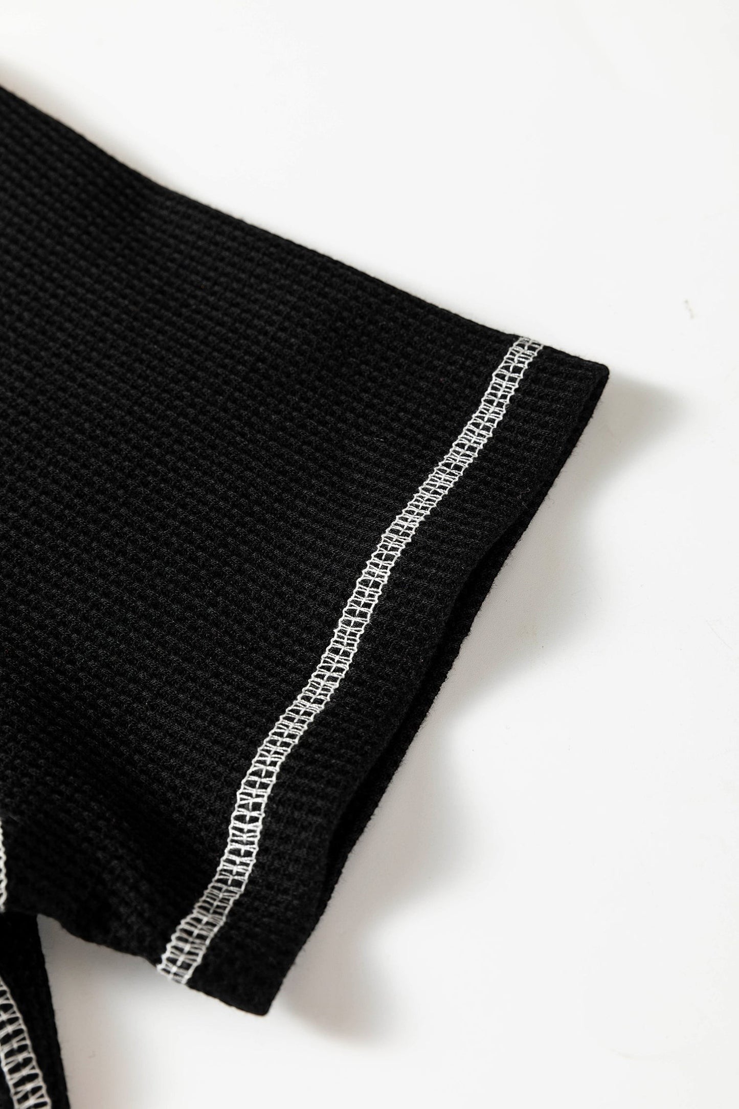 Doodlations Coffee Bar & Boutique black waffle knit top sleeve with white contrast stitching detail