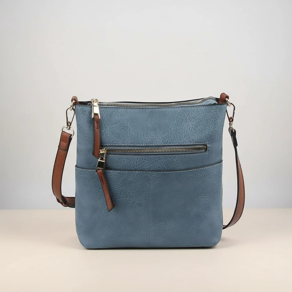 Doodlations Coffee Bar & Boutique blue vegan leather crossbody bag with gold-tone hardware and multiple pockets.