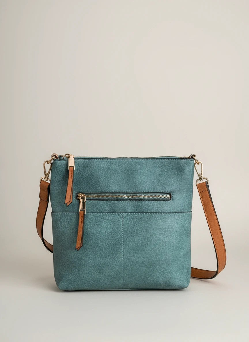 Doodlations Coffee Bar & Boutique blue vegan leather crossbody bag with gold-tone hardware and tan straps.