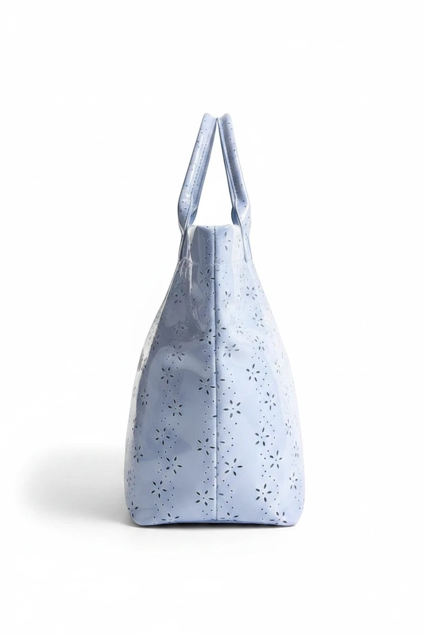 Doodlations Coffee Bar & Boutique baby blue PVC tote bag with a glossy finish and delicate floral eyelet pattern.