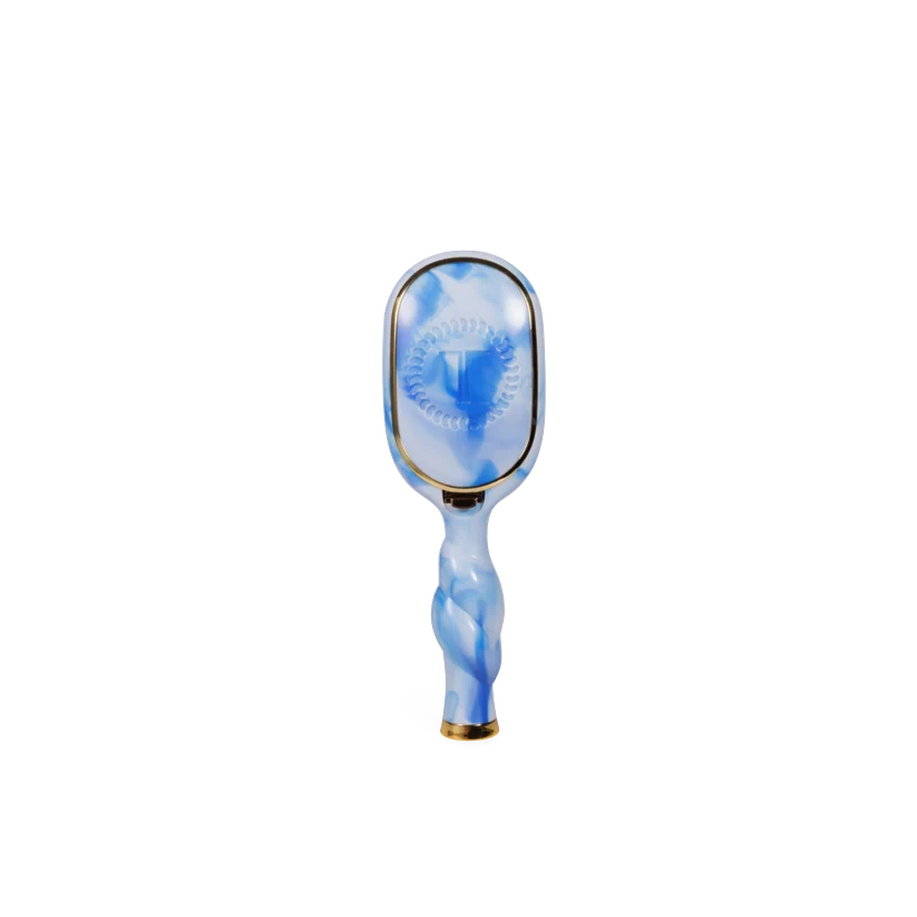 Doodlations Coffee Bar & Boutique Teleties boar bristle hair brush in blue and white marble with a coil handle.