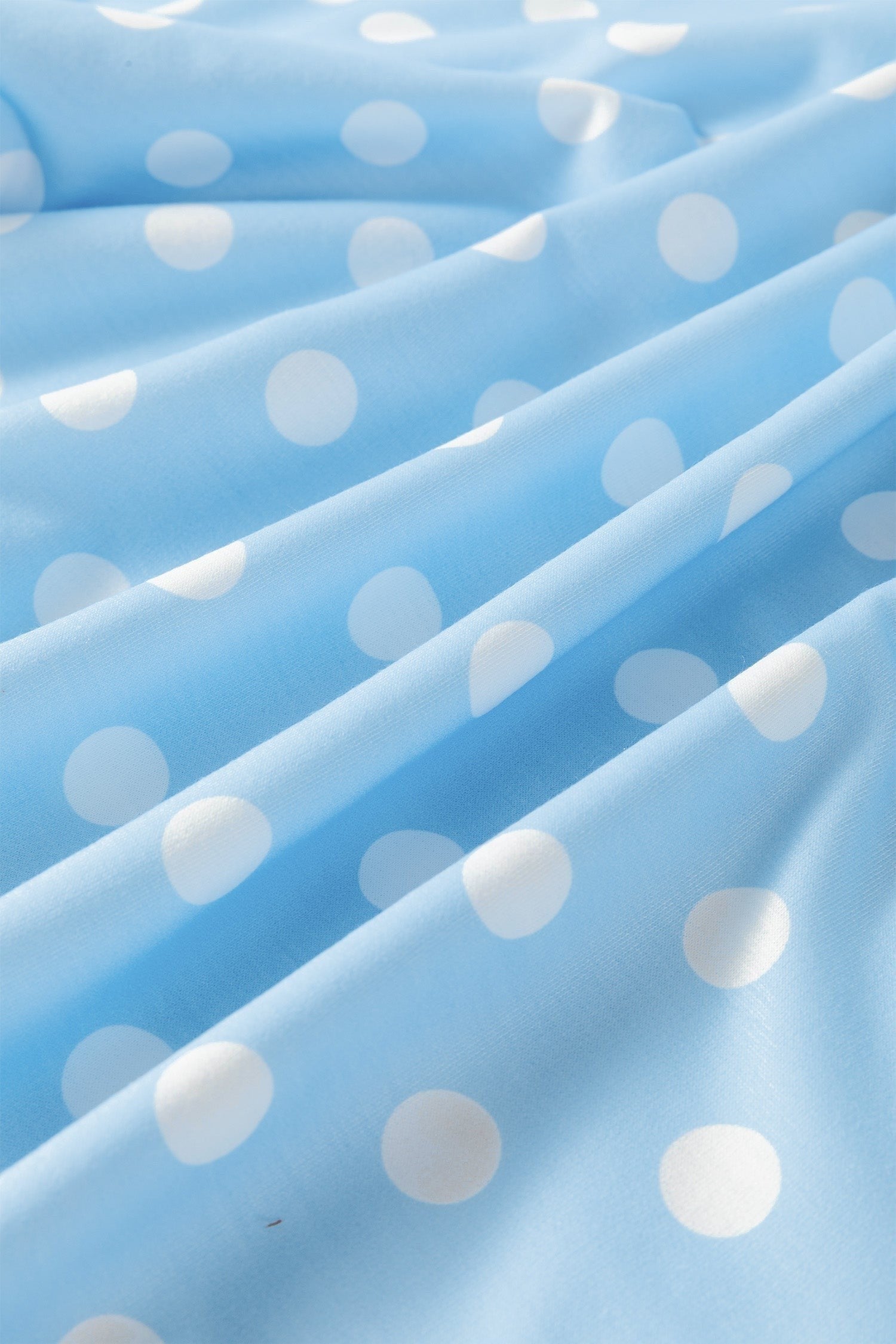 Doodlations Coffee Bar & Boutique light blue fabric with a white polka dot print, soft and breathable lounge material