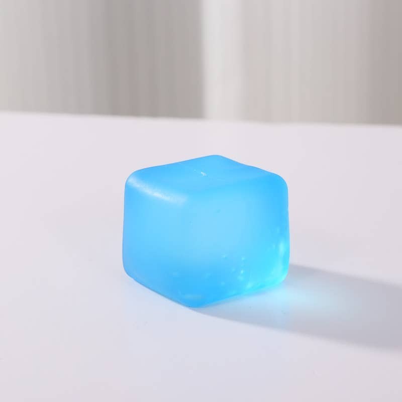 Doodlations Coffee Bar & Boutique blue squishy cube stress toy made of pliable material for sensory play and focus.