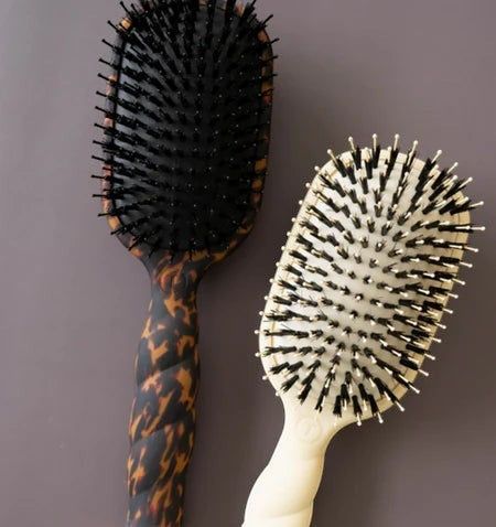Doodlations Coffee Bar & Boutique Teleties boar bristle hair brushes in tan and tortoiseshell with coil handles.