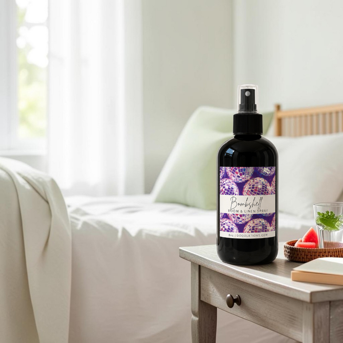 Doodlations Coffee Bar & Boutique Bombshell room and linen spray in a black bottle with a disco ball label design.