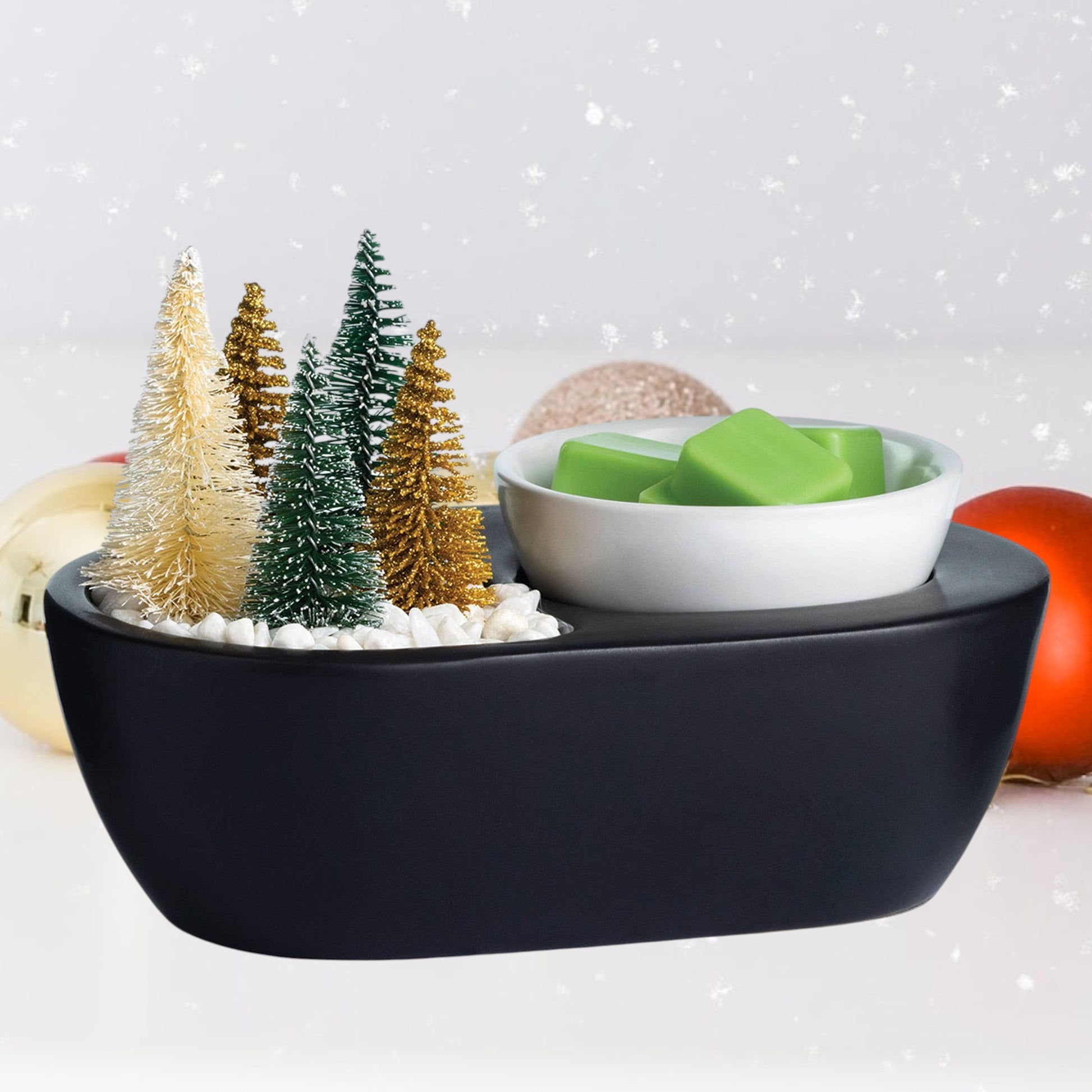 Doodlations Coffee Bar & Boutique black wax warmer with bottle brush trees and green wax melts.
