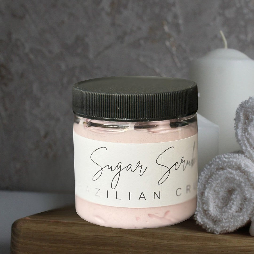 Doodlations Coffee Bar & Boutique Brazil Crush sugar scrub in a clear jar with a black lid. Pink scrub inside.