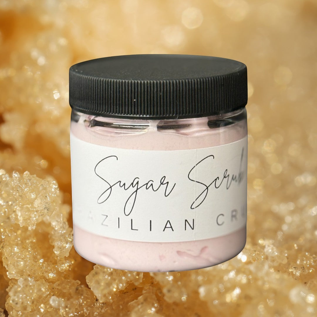 Doodlations Coffee Bar & Boutique Brazil Crush sugar scrub in a clear jar with a black lid. Pink scrub inside.