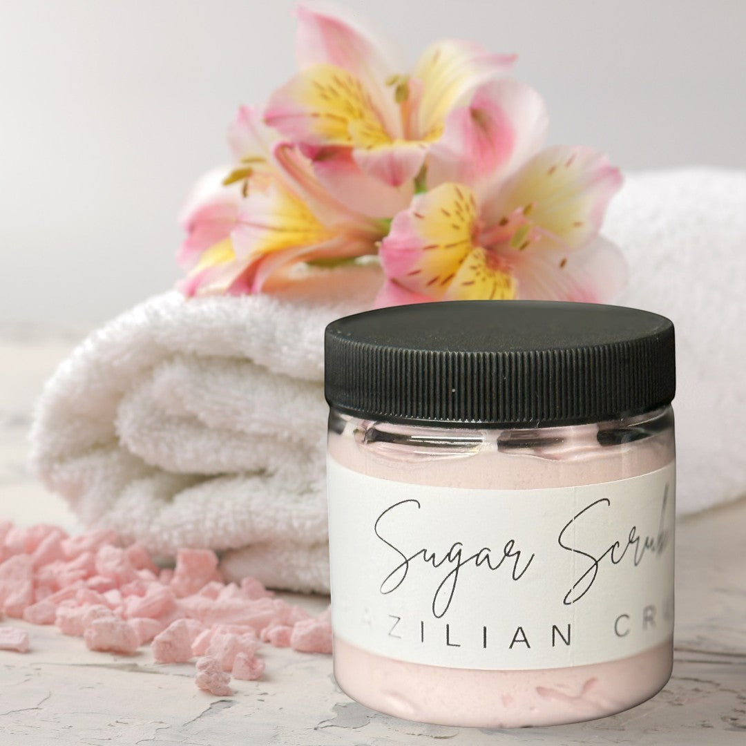 Doodlations Coffee Bar & Boutique Brazil Crush sugar scrub in a clear jar with a black lid. Pink scrub inside.