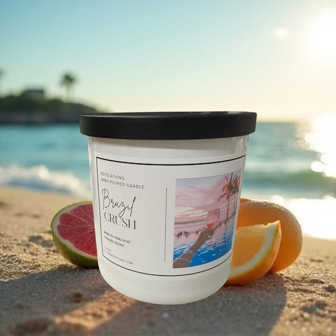 Doodlations Coffee Bar & Boutique Brazilian Crush hand-poured soy blend candle with tropical sunset label.