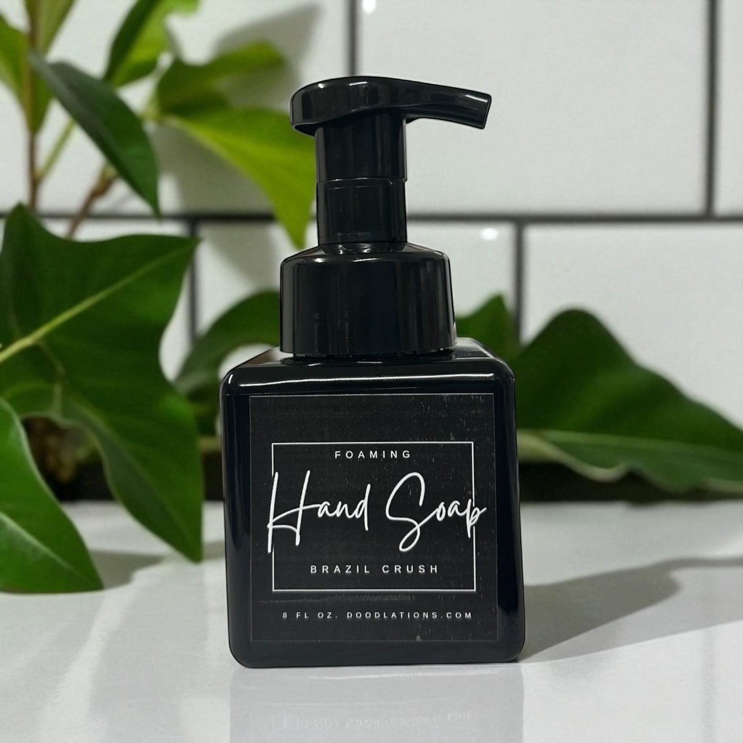 Doodlations Coffee Bar & Boutique Brazilian Crush foaming hand soap in a black bottle with a black pump dispenser.