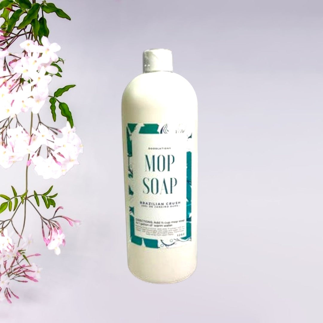 Doodlations Coffee Bar & Boutique Brazilian Crush concentrated mop soap in a white bottle with a teal label. 32 oz.