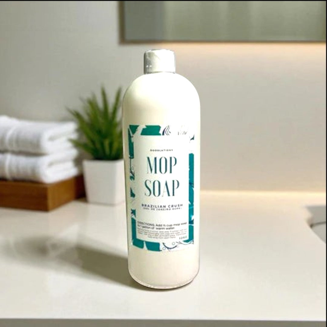 Doodlations Coffee Bar & Boutique Brazilian Crush concentrated mop soap in a white bottle with a teal label.