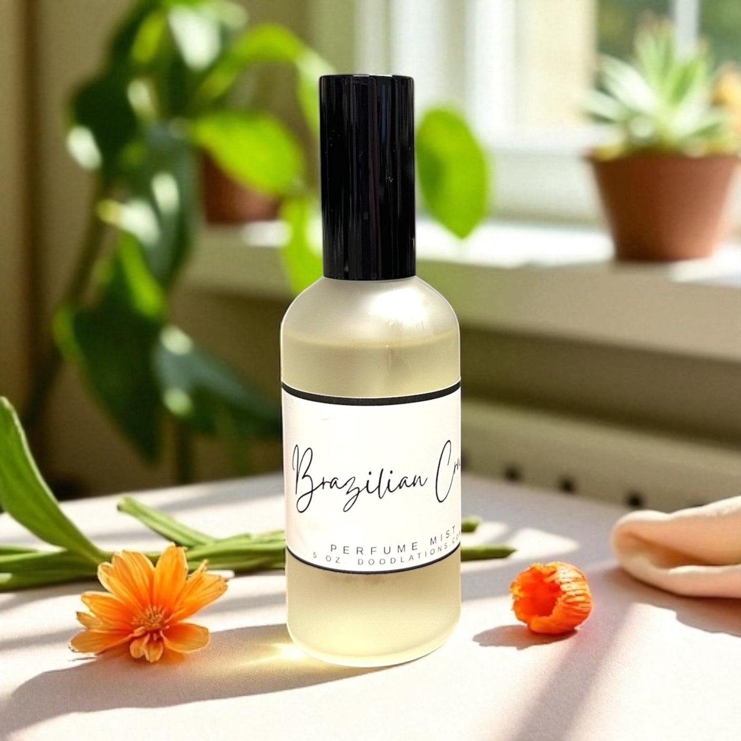 Doodlations Coffee Bar & Boutique Brazilian Crush fine mist perfume in a sleek glass bottle with orange flowers.