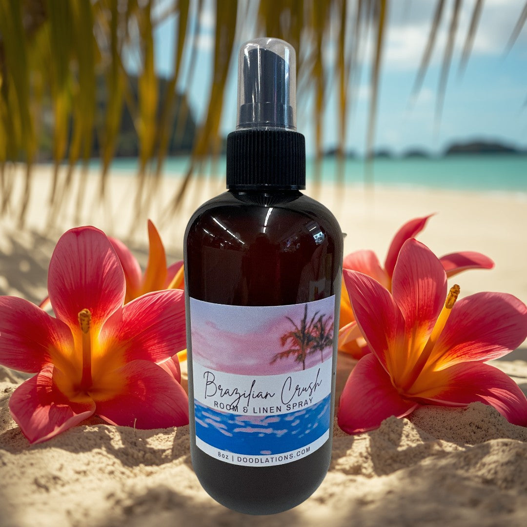 Doodlations Coffee Bar & Boutique Brazilian Crush room and linen spray in amber bottle with tropical sunset label.