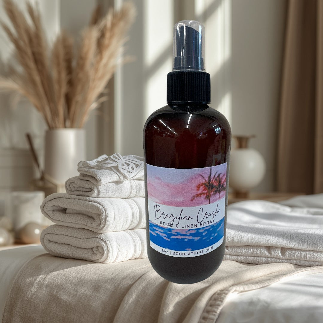 Doodlations Coffee Bar & Boutique Brazilian Crush room and linen spray in amber bottle with tropical sunset label.