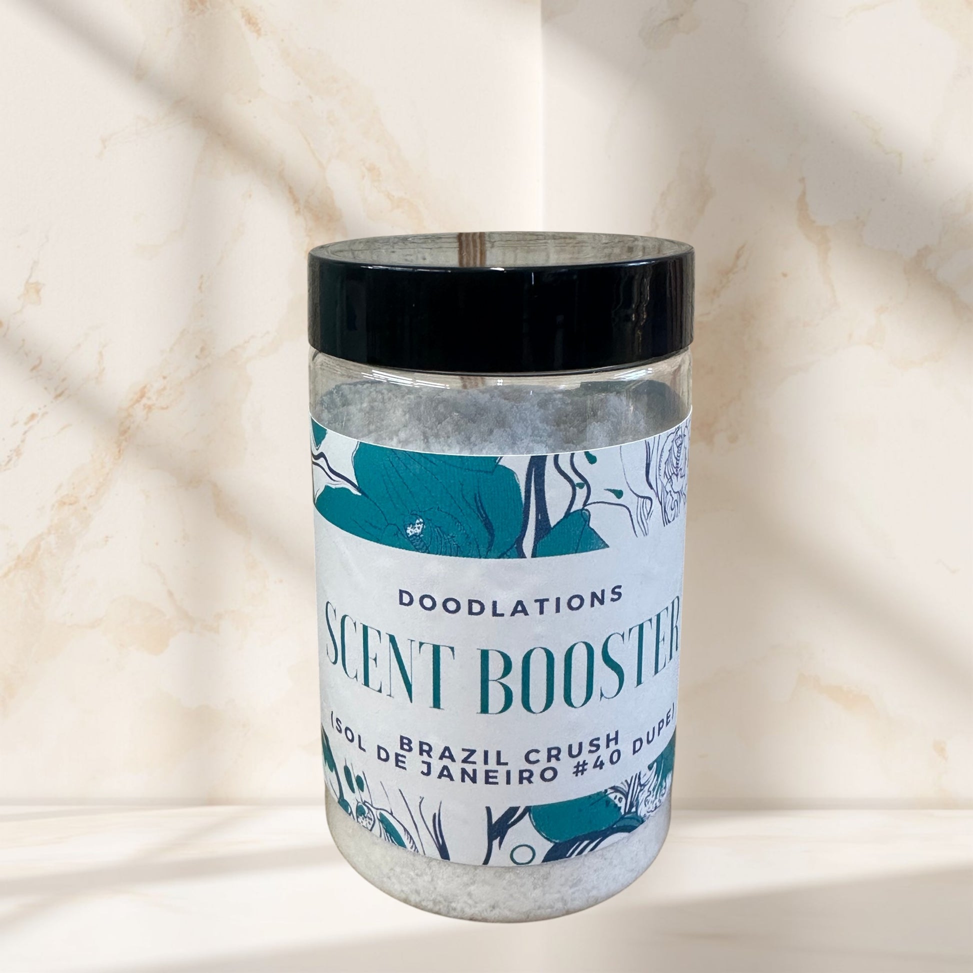 Doodlations Coffee Bar & Boutique Brazilian Crush laundry scent booster in a clear jar with a black lid.