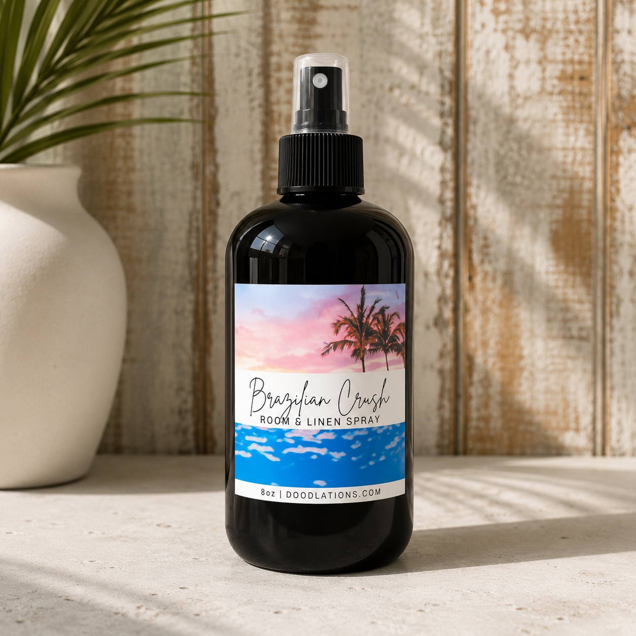 Doodlations Coffee Bar & Boutique Brazilian Crush room and linen spray in a black bottle with tropical sunset label