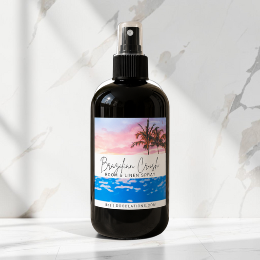 Doodlations Coffee Bar & Boutique Brazilian Crush room and linen spray in a black bottle with a tropical sunset label