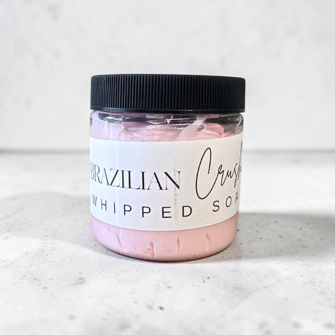 Doodlations Coffee Bar & Boutique Brazilian Crush whipped soap in a 4 oz jar with a black lid and light pink cream.