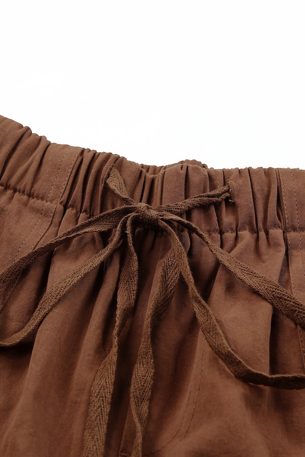 Doodlations Coffee Bar & Boutique brown cotton drawstring shorts with pockets and elastic waist.