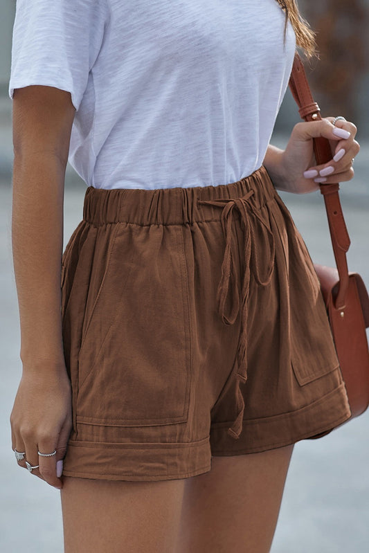 Doodlations Coffee Bar & Boutique brown linen-blend drawstring shorts with pockets and cuffed hem.