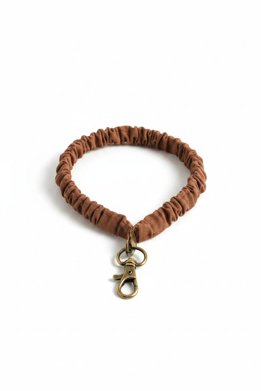 Doodlations Coffee Bar & Boutique Woodland Lanyard in light brown textured fabric with a brass lobster clasp