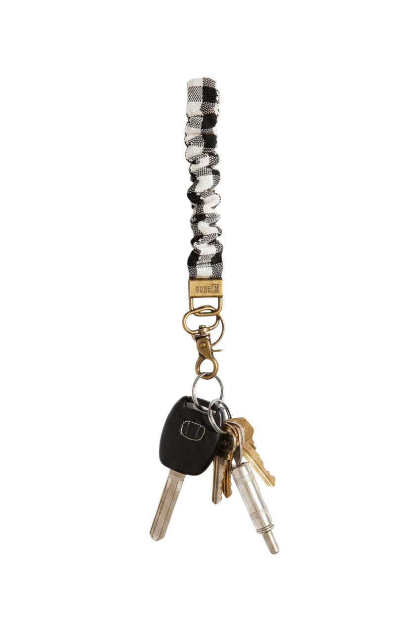 Doodlations Coffee Bar & Boutique black and white buffalo check fabric keychain with brass hardware and keys