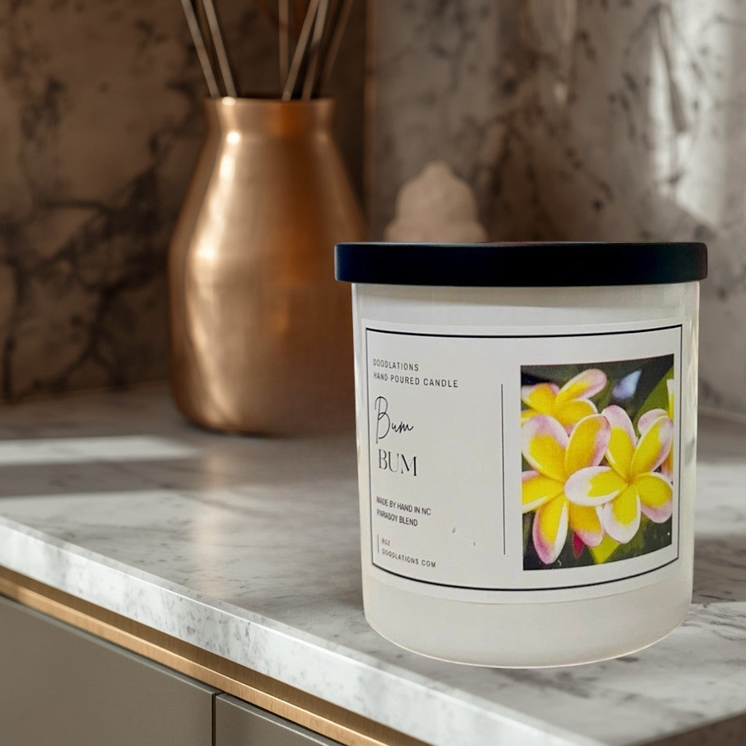 Doodlations Coffee Bar & Boutique Bum Bum luxury hand-poured candle with tropical floral label, 8oz soy blend.