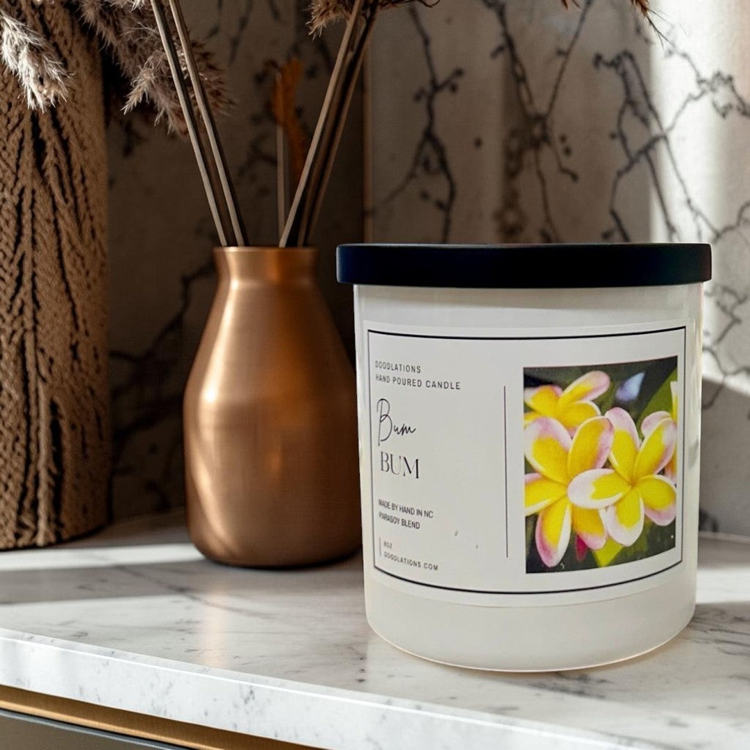 Doodlations Coffee Bar & Boutique Bum Bum luxury hand-poured candle with tropical floral label, 8oz soy blend.