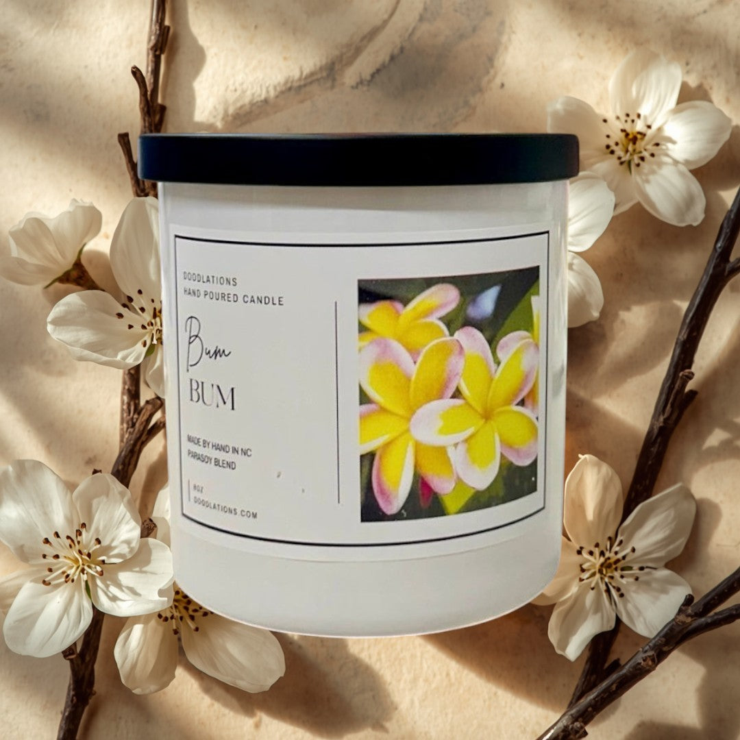 Doodlations Coffee Bar & Boutique Bum Bum luxury hand-poured candle with a tropical floral label.